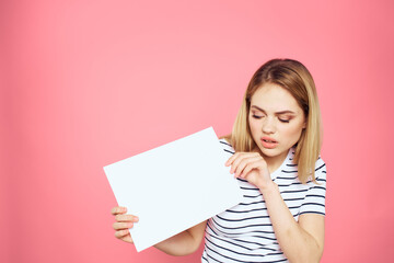 woman holding white sheet in her hands striped t-shirt emotions pink background