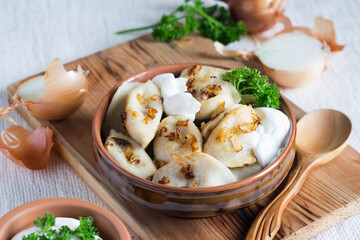 A bowl of russian varenyky, vareniki, Dumplings served with fried onion. Pyrohy - dumplings with filling. Selective focus