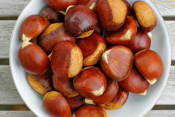 Bowl of fresh chestnuts in the shell in winter