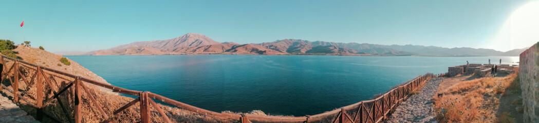 Fototapeta premium wide angle panoramic landspace with mountains, lake on bridge. 