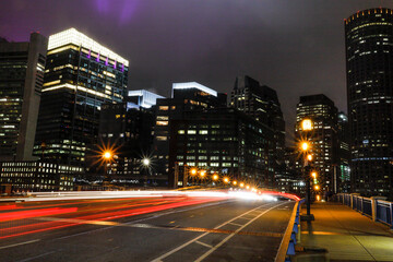 Fototapeta na wymiar Boston, Massachusetts, USA Traffic and light trails on The Seaport Boulevard bridge.