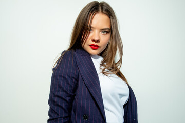 Female success. Business fashion. Leadership empowerment. Portrait of ambitious confident smart woman in blue blazer looking at camera isolated on light neutral copy space background.