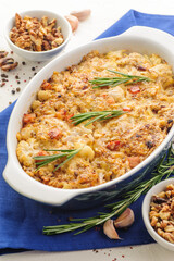 Baked cauliflower with bacon, cheese, nuts, spices and fresh herbs.