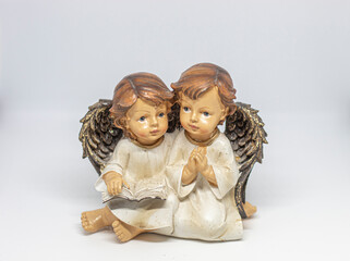 Two angels reading and praying