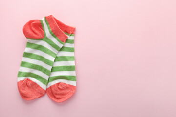 pair of colorful bright socks on pink background with copy space