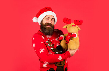 Merry xmas. Happy new year. Oh my deer. Helping Santa Claus. Symbol of Christmas. Christmas eve. Dear Santa. Bearded man reindeer toy. Happy man playful mood. Hipster man hold Christmas gift