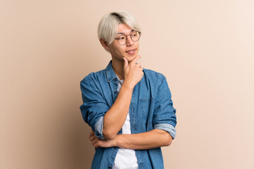 Young asian man over isolated background with glasses