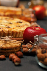 Tart pie and red apple on black table