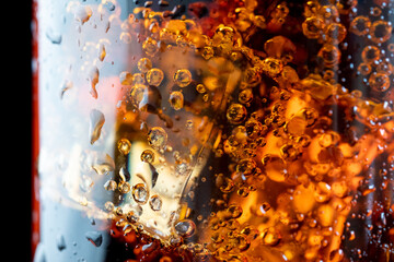 ice cube in fizzy splashing water with soda bubble