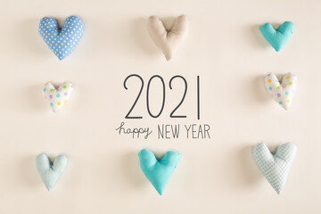 Happy New Year 2021 message with blue heart cushions on a white paper background