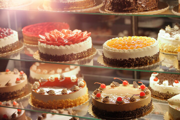 Various types of cakes in a pastry shop for sale and empty space for text