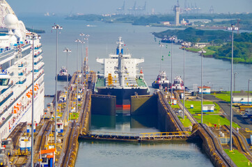 Tanker or cargo container ship transits lock of Panama Canal