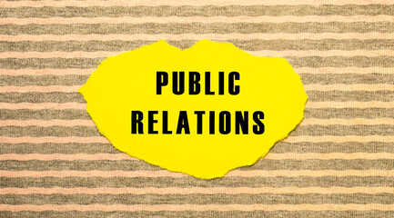Yellow torn paper with the text PUBLIC RELATIONS on a gray-pink background.