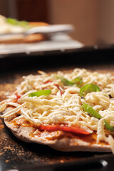 Vegetarian pizza on a wholegrain flour dough is on a baking sheet ready for baking