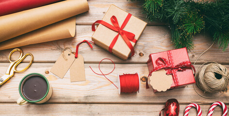 Christmas gift boxes wrapping on wooden background, top view