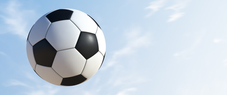 Flying soccer ball against the sky.