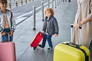 Troubled boy kicking his bag while walking