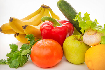 fruits and vegetables on a white background, apples, tomatoes, lemon, garlic, cucumber, pepper, bananas, lettuce leaves close up