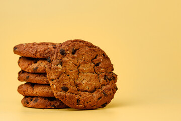 Pile of chocolate chip cookies on yellow backgreound