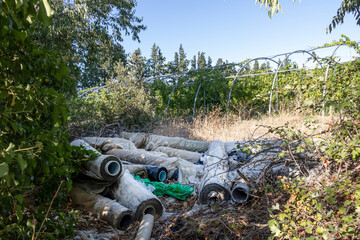 Dump with plastic garbage in the fields, nature pollution with plastic trash from agriculture