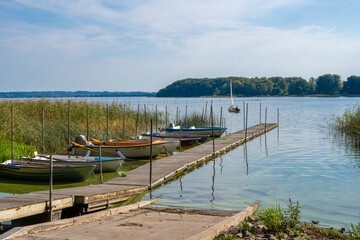 Fototapeta premium A floating jetty and boats in a lake. Picture from Ringsjon, Scania county, Sweden
