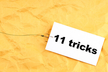 paper on a fish hook with 11 tricks written on it