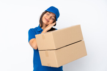 Young delivery brunette girl over isolated white background making sleep gesture in dorable expression