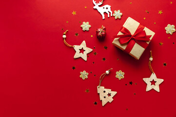 Wooden Christmas toys, gift on a red background.