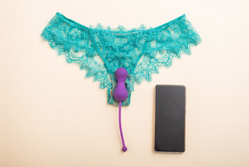 Green lace panties kegel trainer and smartphone. Vibrator synchronized with the application on the...