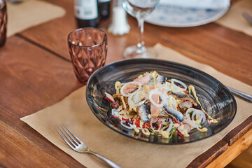 plate with fish salad herring a wooden table