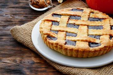 Close up of a berry tart pie on wooden table