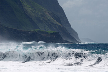 Foamy waves breaking on Kalaupapa leper colony beach on Molokai