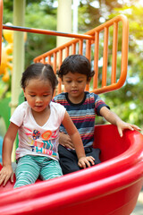 Fototapeta na wymiar Asian girl and asian boy is enjoy on a playground
