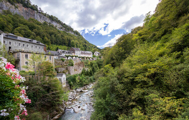 Fototapeta na wymiar River and Eaux-Bonnes picturesque village close to the small town of Laruns, Pyrenees National Park, France