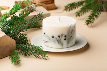 Festive Xmas decorations, homemade gingerbread cookies, fir branches on natural beige background.