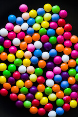 Fototapeta na wymiar Skittles candy on the table, colorful sweet candy