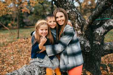 Mother with children in autumn park