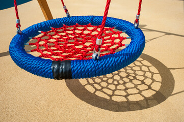 shadow from the children's wicker swing on the background of the Playground