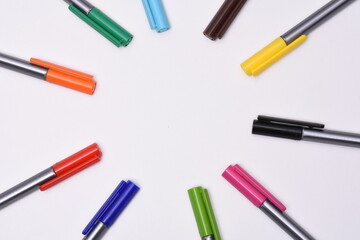 Сolored markers on the tables with notebooks