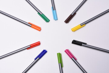 Сolored markers on the tables with notebooks