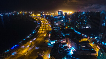 Road, lights and sea at night.
Luanda city captured from the top