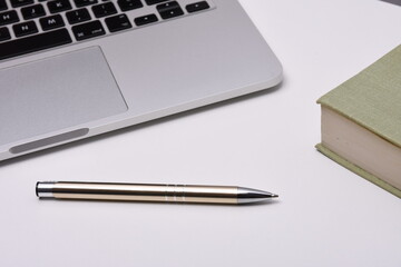 Laptop on desk with stickers and pen for business