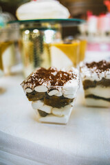 A variety of colored desserts in a glass. Colorful jelly dessert in a glass. Multicolored cream dessert in a glass.
