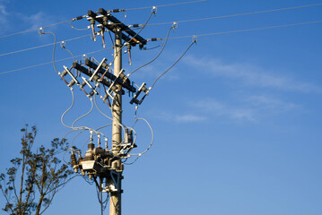 Electricity pole and transmission equipment on blue background