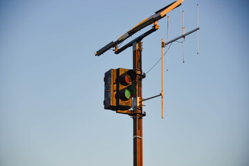 Railway traffic light and data transmission antenna on blue background