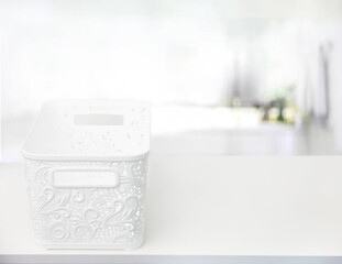 Plastic white openwork box on white table