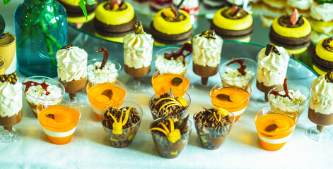 A variety of colored desserts in a glass. Colorful jelly dessert in a glass. Multicolored cream dessert in a glass.
