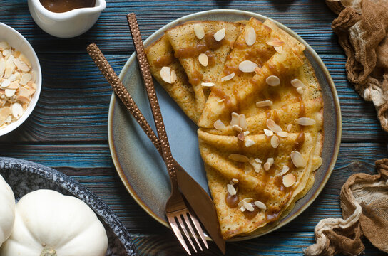 Pumpkin pancakes with date syrup and almonds