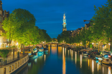 Westerkerk church tower at canal in  Amsterdam, Netherlands