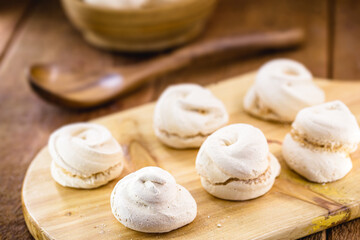 Fototapeta na wymiar portion of homemade cookies, called meringue or sighs, typical egg yolk cake with sugar
